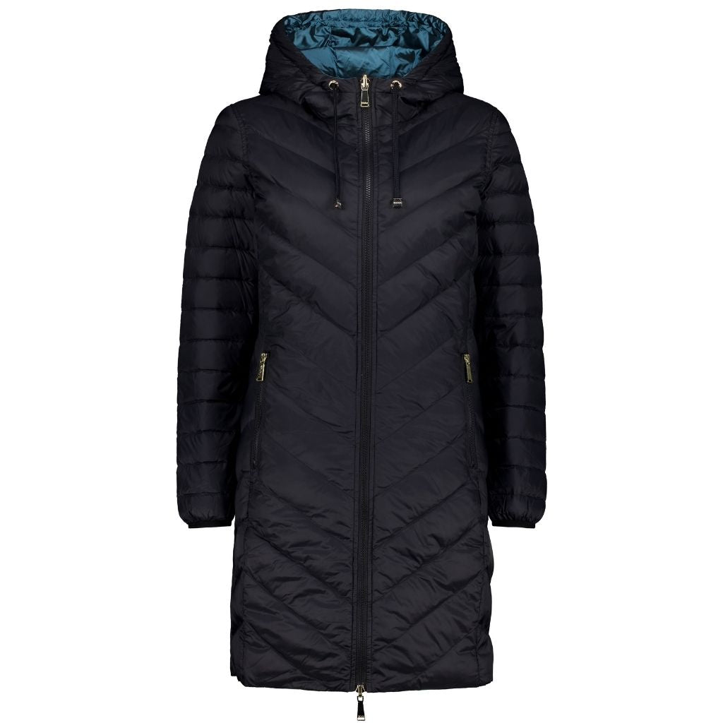 A woman's reversible down coat with a quilted design, main color is black with empire blue lining visible at the hood, zipper front, and hood with adjustable drawstrings.